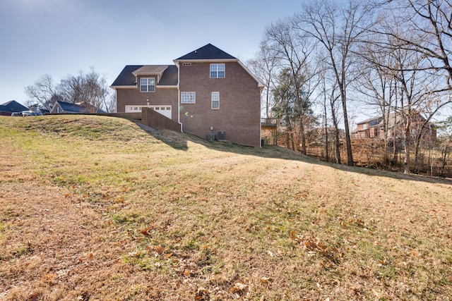 view of side of property featuring a yard and a garage