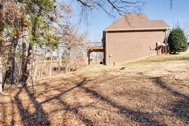 view of property exterior with a yard and a deck