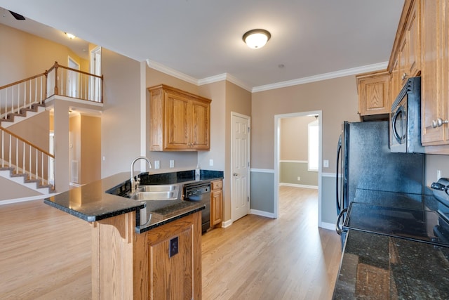 kitchen with kitchen peninsula, light wood-type flooring, crown molding, dark stone countertops, and dishwasher