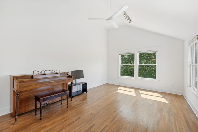 misc room with track lighting, light hardwood / wood-style floors, ceiling fan, and vaulted ceiling