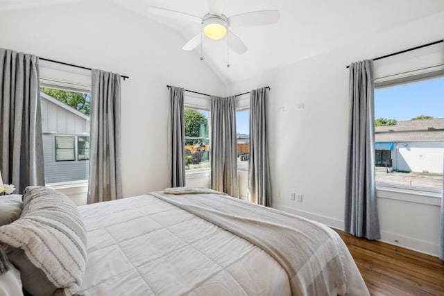 bedroom featuring hardwood / wood-style floors, ceiling fan, lofted ceiling, and multiple windows