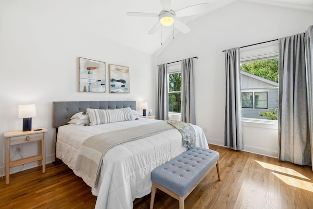 bedroom with ceiling fan, light hardwood / wood-style flooring, and lofted ceiling