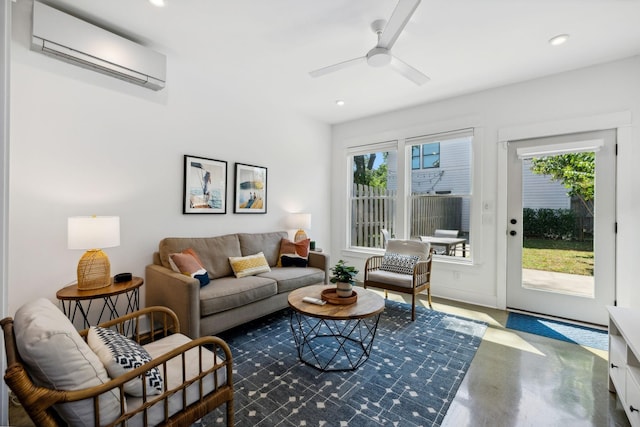 living room with a wall mounted air conditioner, plenty of natural light, and ceiling fan