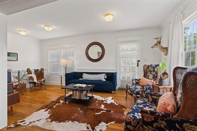 living room with light hardwood / wood-style flooring and ornamental molding