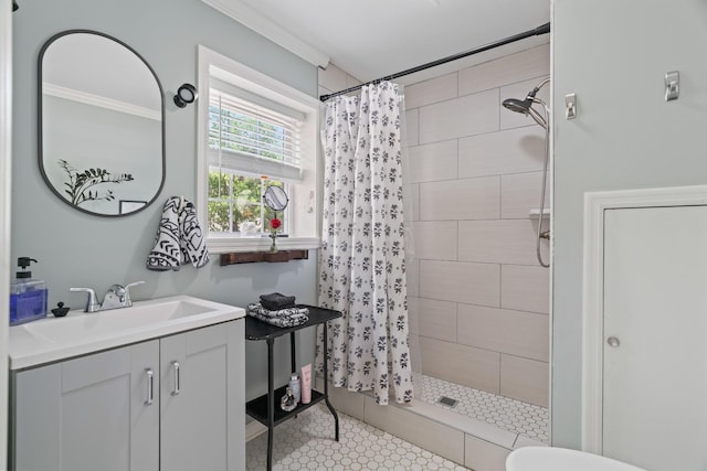 bathroom featuring tile patterned flooring, vanity, ornamental molding, and walk in shower