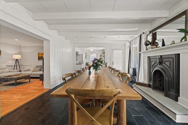 dining space featuring beam ceiling