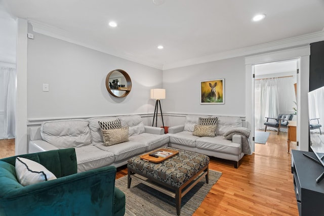 living room featuring light hardwood / wood-style flooring and crown molding