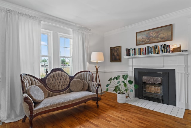 sitting room featuring hardwood / wood-style floors and crown molding