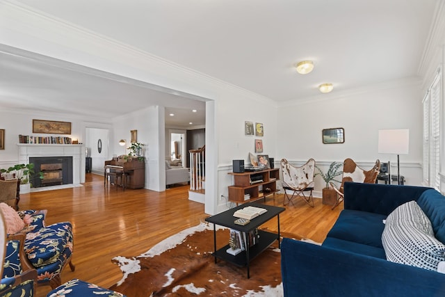 living room featuring hardwood / wood-style flooring and ornamental molding