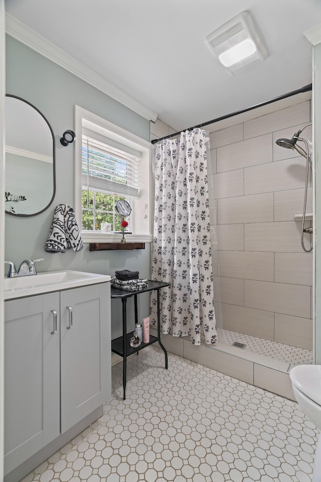 bathroom with toilet, vanity, ornamental molding, and a shower with shower curtain