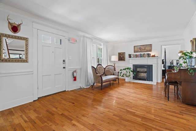 entrance foyer with ornamental molding and light wood-type flooring