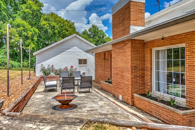 view of patio / terrace featuring an outdoor fire pit