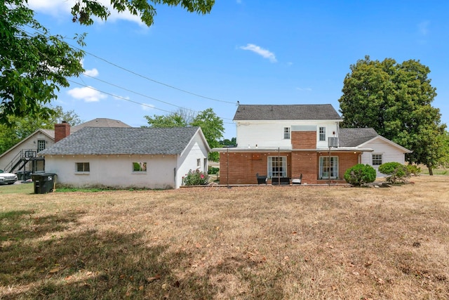 rear view of house featuring a yard