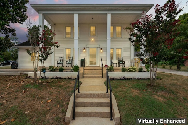 neoclassical / greek revival house featuring a lawn