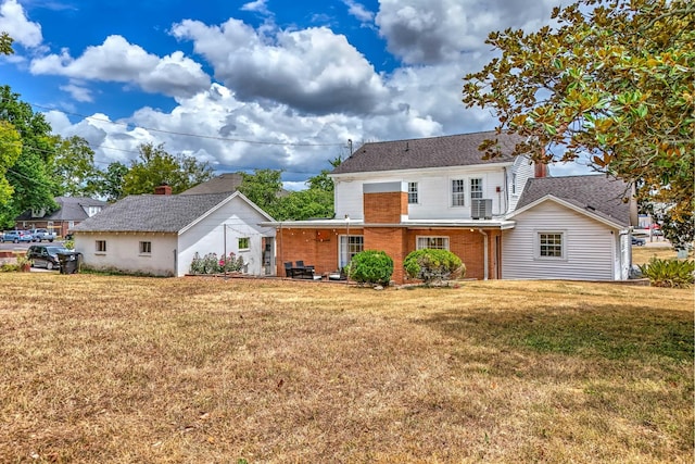 back of property featuring a yard