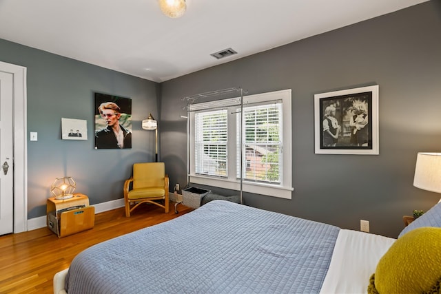 bedroom with hardwood / wood-style floors