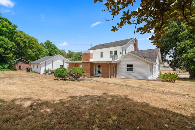 rear view of house with a yard