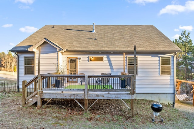 back of property featuring a wooden deck