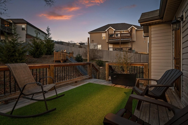 yard at dusk featuring a playground