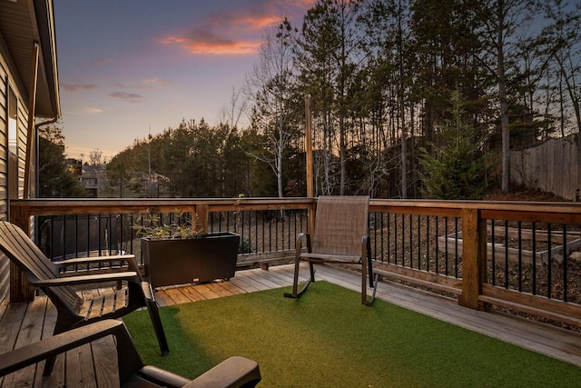 deck at dusk with a lawn