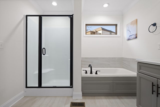 bathroom with crown molding, vanity, and independent shower and bath