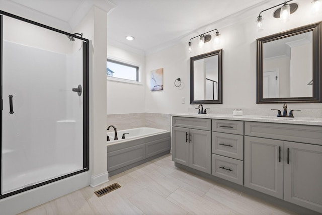 bathroom with separate shower and tub, vanity, and ornamental molding