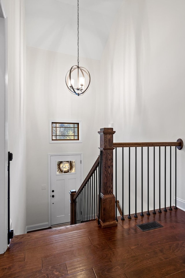 entryway featuring a notable chandelier and dark hardwood / wood-style floors