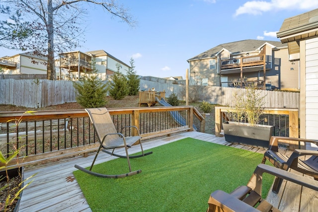 view of yard with a deck and a playground