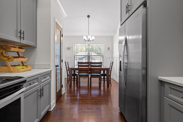 kitchen featuring gray cabinets, a notable chandelier, stainless steel fridge, and pendant lighting