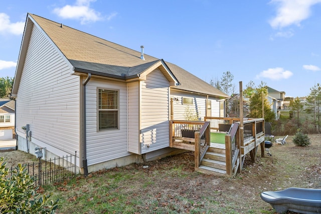 view of side of property featuring a wooden deck