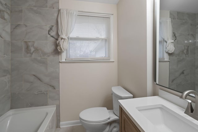 full bathroom featuring toilet, tiled shower / bath combo, and vanity