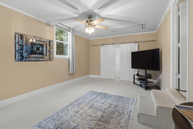 carpeted living room with ceiling fan and ornamental molding