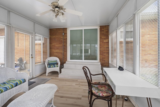 sunroom featuring ceiling fan