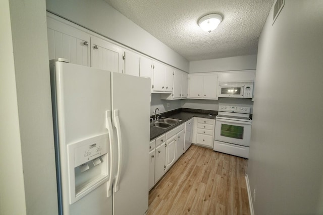 kitchen featuring sink, light hardwood / wood-style floors, a textured ceiling, white appliances, and white cabinets