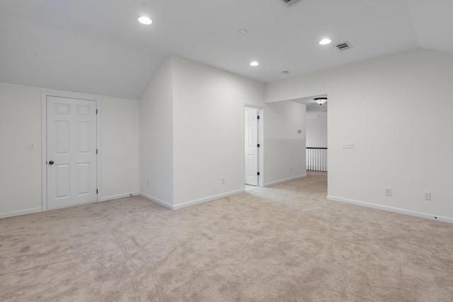 bonus room with light colored carpet and lofted ceiling