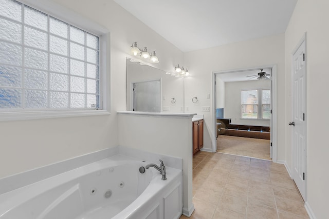 bathroom with a washtub, vanity, ceiling fan, and tile patterned flooring