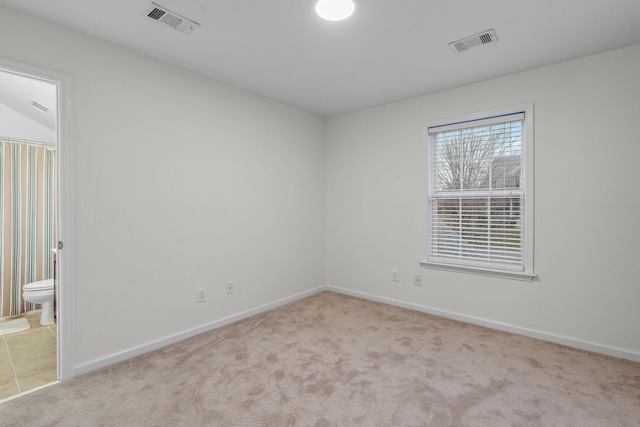 empty room with light colored carpet