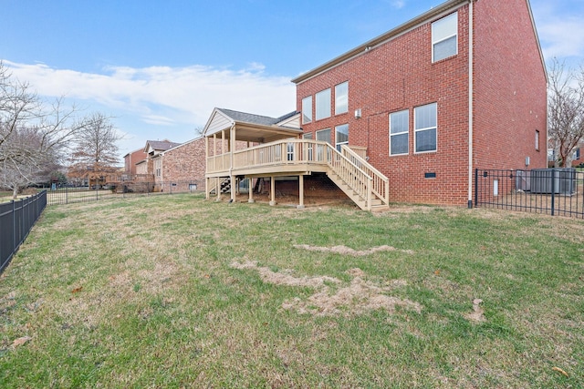 back of property featuring a yard and a wooden deck