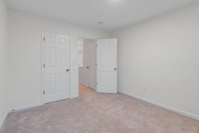 unfurnished bedroom with light carpet