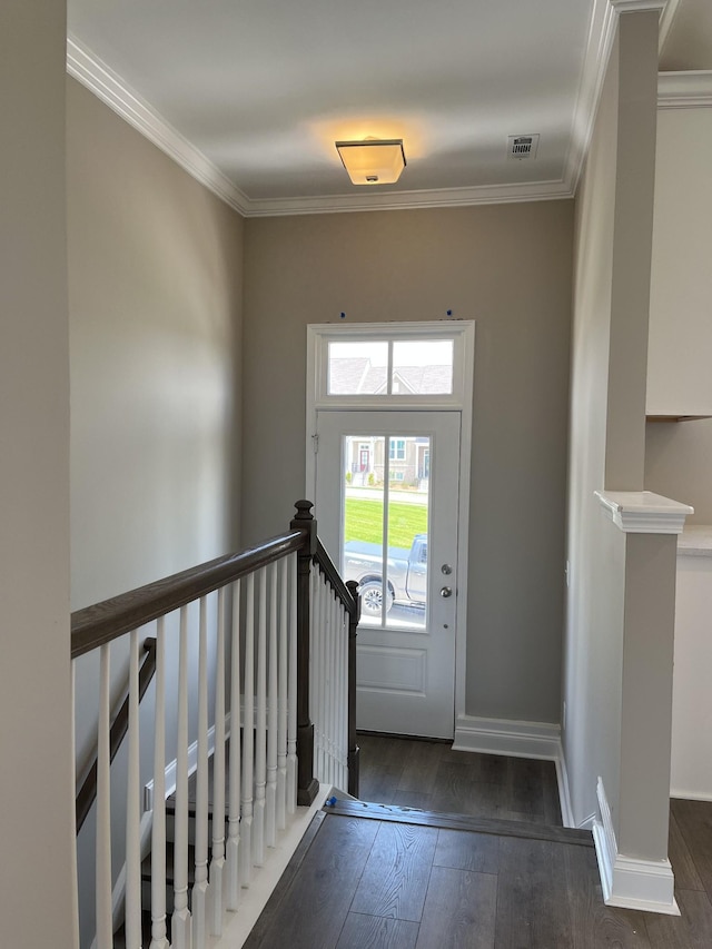 foyer entrance with dark hardwood / wood-style floors and ornamental molding