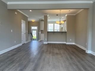 unfurnished living room featuring dark wood-type flooring, radiator, and ornamental molding