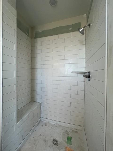 bathroom featuring a shower and concrete flooring