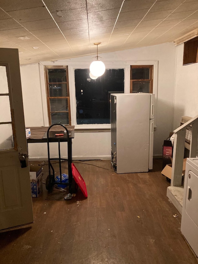 interior space with dark hardwood / wood-style flooring and washer / dryer