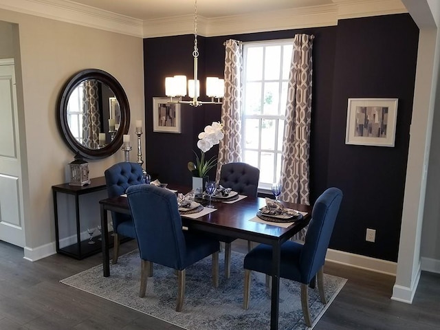 dining room with dark hardwood / wood-style floors, an inviting chandelier, and ornamental molding