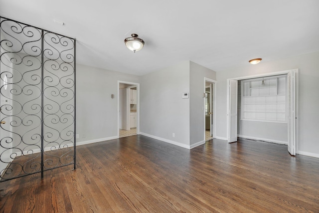 unfurnished bedroom with a closet and dark wood-type flooring