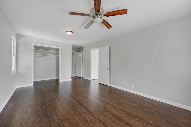 unfurnished bedroom with a closet, ceiling fan, and dark wood-type flooring