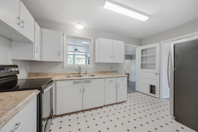 kitchen featuring white cabinetry, stainless steel fridge, sink, and black electric range oven