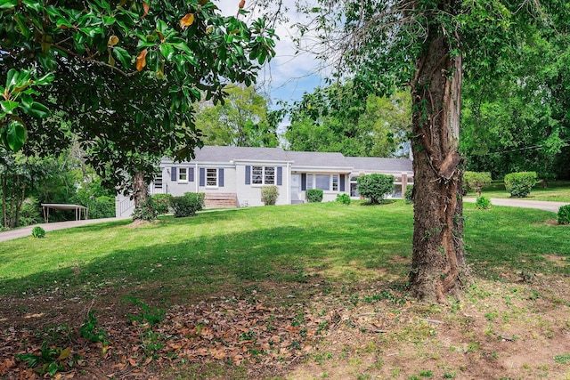 ranch-style home with a front lawn