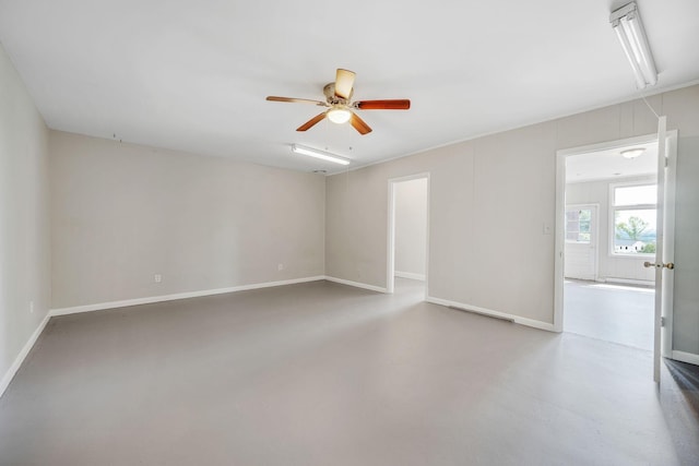 unfurnished room featuring ceiling fan and concrete flooring