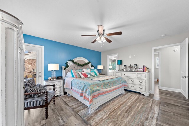 bedroom featuring hardwood / wood-style flooring, ceiling fan, and multiple windows